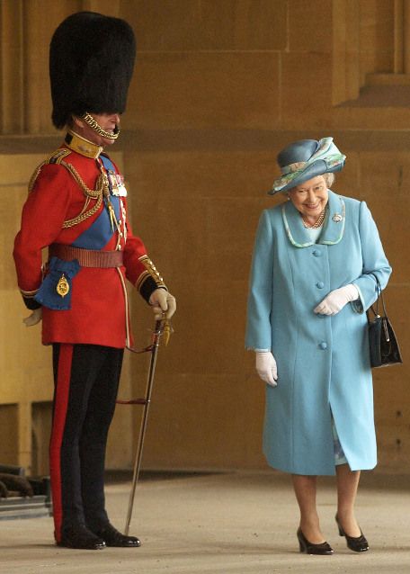 The Queen laughing as she passes her husband, the Duke of Edinburgh, in uniform. - Imgur.jpg